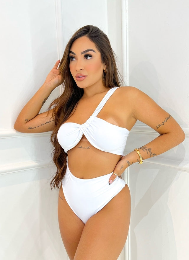 model wearing a white high-waisted bikini set with a knot-front top