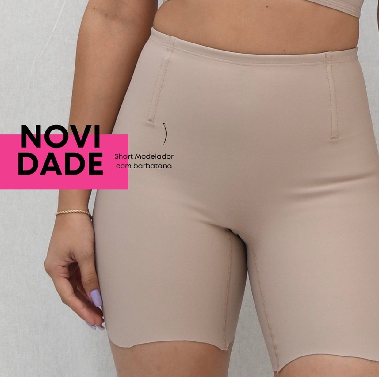 A person wearing beige short-modeling second skin shorts, with a close-up view on the lower part of the shorts.