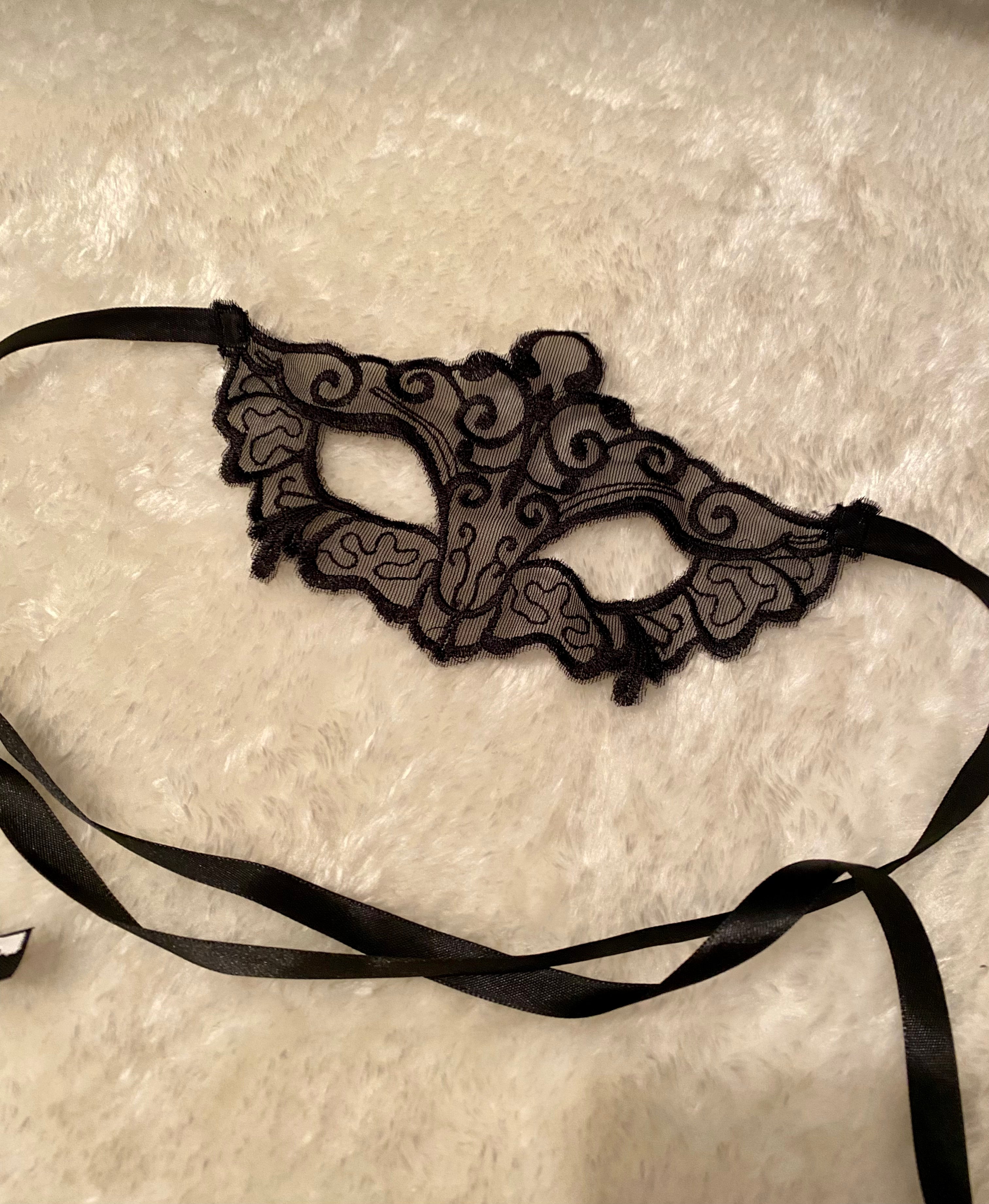 This image features an elegant "Sexy tie mask," designed with intricate, swirling black lace patterns. The mask is lightweight and appears to have a narrow black ribbon for securing around the head, suggesting a snug fit.